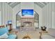 Cozy fireplace in the pool house with a TV and comfortable seating at 7858 Gull Bay Dr, Awendaw, SC 29429