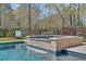 Inviting pool and spa area with a waterfall feature and lounge seating at 7858 Gull Bay Dr, Awendaw, SC 29429