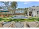 Relaxing backyard featuring a beautiful pool, spa, outdoor kitchen, and dining area at 7858 Gull Bay Dr, Awendaw, SC 29429