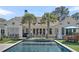 A beautiful pool and palm trees on a sunny day at 7858 Gull Bay Dr, Awendaw, SC 29429