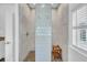 Stylish walk-in shower with unique tiling and a built-in bench at 7858 Gull Bay Dr, Awendaw, SC 29429