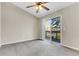 Bedroom with an exterior view and a balcony through sliding glass doors with neutral paint and carpeting at 7875 Sandida Ct, North Charleston, SC 29418