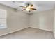 An empty carpeted bedroom with a ceiling fan and a window at 7875 Sandida Ct, North Charleston, SC 29418