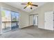 Neutral bedroom with fan, closet and sliding glass doors leading to an outdoor balcony at 7875 Sandida Ct, North Charleston, SC 29418