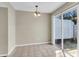 Open-concept dining room with ceramic tile floors and a sliding glass door leading to the backyard at 7875 Sandida Ct, North Charleston, SC 29418