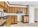 Traditional kitchen featuring wooden cabinets, a stainless steel microwave, and a double basin sink at 7875 Sandida Ct, North Charleston, SC 29418