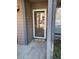 Exterior view of the front entrance, featuring a welcome mat, a screen door and gray columns at 7945 Edgebrook Cir # B, North Charleston, SC 29418