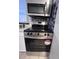 Close-up of stainless steel oven and microwave with mosaic backsplash and a white cabinet at 7945 Edgebrook Cir # B, North Charleston, SC 29418