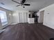 A living room that features wood-look flooring, ceiling fan, kitchen, and a white front door at 7945 Edgebrook Cir # B, North Charleston, SC 29418