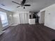 Living room with ceiling fan, wood-look flooring, a large window with blinds, and a kitchen at 7945 Edgebrook Cir # B, North Charleston, SC 29418
