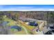 Stunning aerial view of a home near a golf course and water feature, backing up to a vibrant forest at 8638 Scottish Troon Ct, North Charleston, SC 29420
