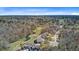 An aerial view of a home nestled among lush greenery with a golf course nearby, showcasing serene pond and surrounding trees at 8638 Scottish Troon Ct, North Charleston, SC 29420