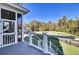 The back porch provides a tranquil escape with scenic views of the lush backyard, treeline, and the golf course at 8638 Scottish Troon Ct, North Charleston, SC 29420