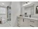 Modern bathroom with marble floors, a glass-enclosed shower, and white vanity with a stylish mirror at 8638 Scottish Troon Ct, North Charleston, SC 29420