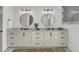 Bright bathroom featuring double sinks, round mirrors, modern fixtures, and chandelier at 8638 Scottish Troon Ct, North Charleston, SC 29420