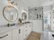 Bright bathroom featuring double sinks, round mirrors, modern fixtures, and glass shower at 8638 Scottish Troon Ct, North Charleston, SC 29420