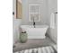 Bright bathroom featuring standalone tub, stool, and window with white blinds at 8638 Scottish Troon Ct, North Charleston, SC 29420
