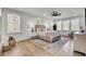 Bright bedroom with a ceiling fan, hardwood floors, neutral decor, and windows with natural light at 8638 Scottish Troon Ct, North Charleston, SC 29420