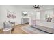 Bright bedroom with a ceiling fan, hardwood floors, neutral decor, and modern lighting fixtures at 8638 Scottish Troon Ct, North Charleston, SC 29420