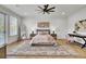 Bright bedroom with a ceiling fan, hardwood floors, neutral decor, and a decorative rug at 8638 Scottish Troon Ct, North Charleston, SC 29420