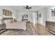 Bright bedroom featuring a ceiling fan, hardwood floors, neutral decor, and a decorative rug at 8638 Scottish Troon Ct, North Charleston, SC 29420