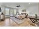 Spacious bedroom featuring hardwood floors, ample natural light, a ceiling fan and a stylish rug at 8638 Scottish Troon Ct, North Charleston, SC 29420