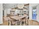 Open-concept dining area featuring a kitchen island and a rustic wooden table at 8638 Scottish Troon Ct, North Charleston, SC 29420