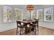 Cozy dining area bathed in natural light, features a rustic wooden table perfect for intimate meals at 8638 Scottish Troon Ct, North Charleston, SC 29420