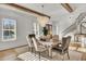 Bright dining room with stylish lighting fixture, wood beams, and comfortable seating at 8638 Scottish Troon Ct, North Charleston, SC 29420
