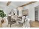 Chic dining room with elegant chandelier, wood beam accents, and ample seating for entertaining at 8638 Scottish Troon Ct, North Charleston, SC 29420