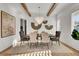 Bright dining room features statement chandelier, wood beams and stylish decor at 8638 Scottish Troon Ct, North Charleston, SC 29420
