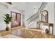 Elegant foyer with hardwood floors, grand staircase, and abundant natural light at 8638 Scottish Troon Ct, North Charleston, SC 29420