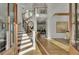 Stunning foyer with high ceilings, elegant staircase, and beautiful hardwood floors at 8638 Scottish Troon Ct, North Charleston, SC 29420