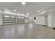 Large three-car garage featuring epoxy flooring, ample lighting, and three garage doors at 8638 Scottish Troon Ct, North Charleston, SC 29420