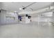 Well-organized garage with epoxy flooring, ample storage cabinets, and efficient lighting fixtures at 8638 Scottish Troon Ct, North Charleston, SC 29420