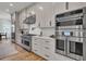Modern kitchen featuring stainless steel appliances, white cabinetry, and sleek countertops, perfect for culinary enthusiasts at 8638 Scottish Troon Ct, North Charleston, SC 29420