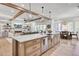 Bright, open-concept living space featuring a kitchen island, fireplace, and exposed beam ceiling at 8638 Scottish Troon Ct, North Charleston, SC 29420