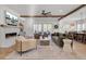Open living room with fireplace, wood beams and access to outdoor space at 8638 Scottish Troon Ct, North Charleston, SC 29420