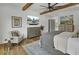 Comfortable main bedroom with wood beams, TV, decorative rug and adjoining bath at 8638 Scottish Troon Ct, North Charleston, SC 29420