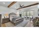 Relaxing main bedroom with hardwood floors, ceiling fan, and access to an outdoor patio at 8638 Scottish Troon Ct, North Charleston, SC 29420