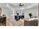 Bright home office with tray ceiling, modern desk, and ample natural light from two large windows at 8638 Scottish Troon Ct, North Charleston, SC 29420