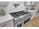 Close-up of stainless steel range with white countertop and modern finishes at 8638 Scottish Troon Ct, North Charleston, SC 29420