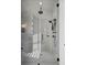 Modern shower with rainfall shower head, handheld sprayer, and tiled walls at 8638 Scottish Troon Ct, North Charleston, SC 29420