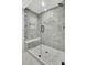 Sleek walk-in shower with light gray subway tile, mosaic tile floor, and a comfortable built-in bench at 8638 Scottish Troon Ct, North Charleston, SC 29420