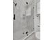 Modern shower featuring gray and white tiles, glass enclosure, and sleek black hardware at 8638 Scottish Troon Ct, North Charleston, SC 29420