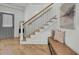 Entryway with wooden staircase, natural light, bench seat, and access to basement at 8638 Scottish Troon Ct, North Charleston, SC 29420