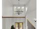 Staircase with iron railing leading to the second floor, with a large pendant light at 8638 Scottish Troon Ct, North Charleston, SC 29420