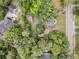 An aerial view showcases the property nestled among mature trees, near a quiet street at 914 S Main St, Summerville, SC 29483
