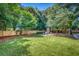 Large grassy backyard with a charming fire pit perfect for outdoor entertaining at 914 S Main St, Summerville, SC 29483