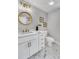 Bright bathroom boasts stylish vanity, modern fixtures, gold accents, and marble floors at 914 S Main St, Summerville, SC 29483